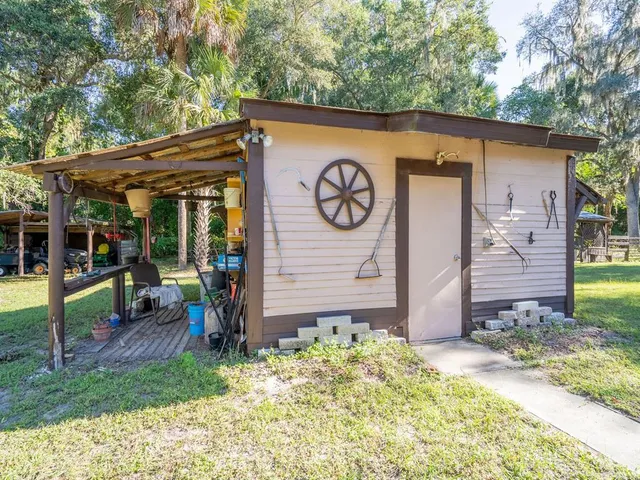a backyard of a house with table and chairs
