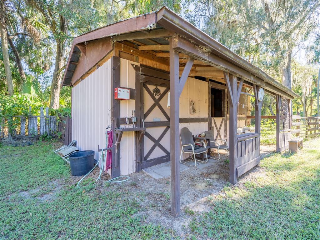 15429 Northeast 38th Court Citra, FL 32113 - Photo 28 of 53 a backyard of a house with table and chairs