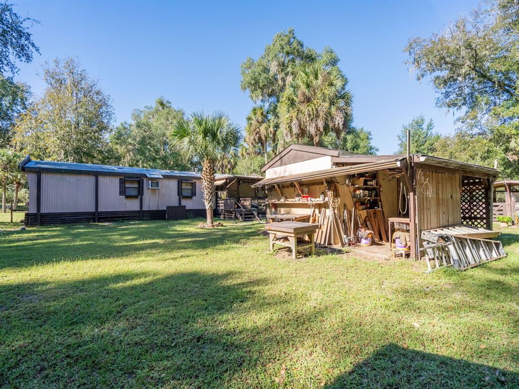 15429 Northeast 38th Court Citra, FL 32113 - Photo 31 of 53 a view of a house with a yard patio and sitting area