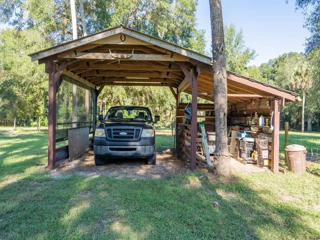 a view of a house with swimming pool and a yard