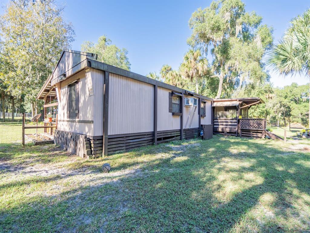 15429 Northeast 38th Court Citra, FL 32113 - Photo 40 of 53 a backyard of a house with barbeque oven and seating space