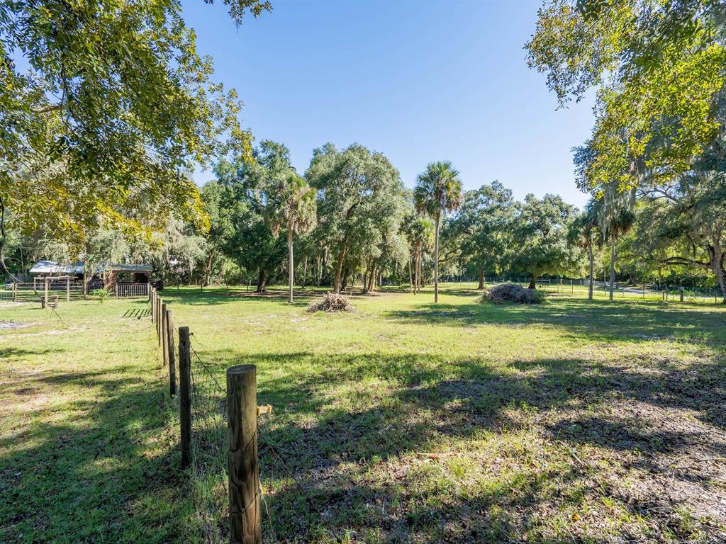 15429 Northeast 38th Court Citra, FL 32113 - Photo 43 of 53 a swimming pool with outdoor seating and yard