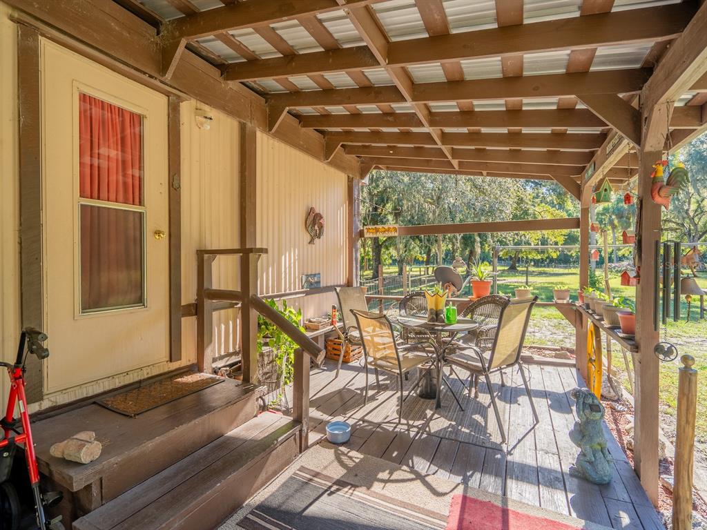 15429 Northeast 38th Court Citra, FL 32113 - Photo 7 of 53 a view of a porch with furniture and next to a window