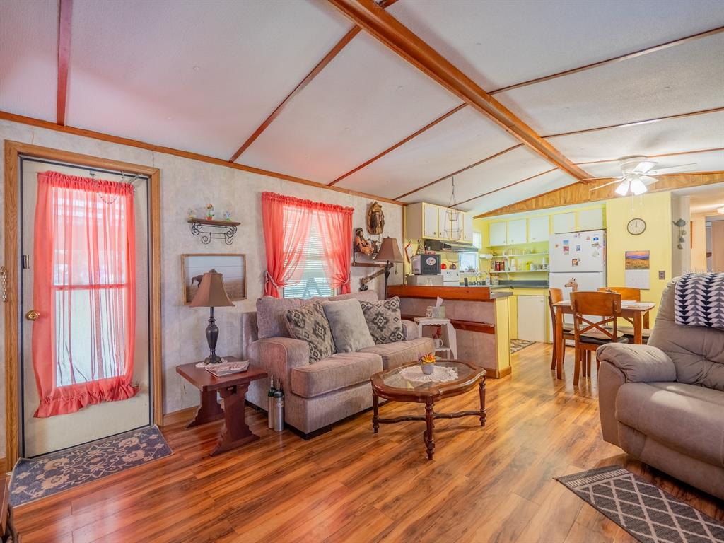 15429 Northeast 38th Court Citra, FL 32113 - Photo 8 of 53 a living room with furniture a wooden floor and next to a window
