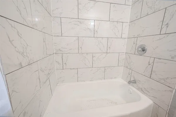 a white bath tub sitting in a bathroom