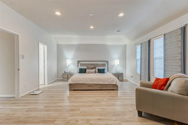 a bedroom with a large bed and a couch