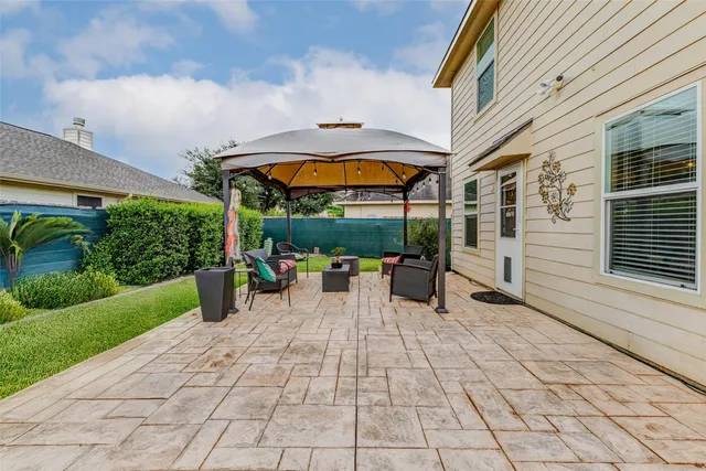a view of a house with backyard porch and sitting area