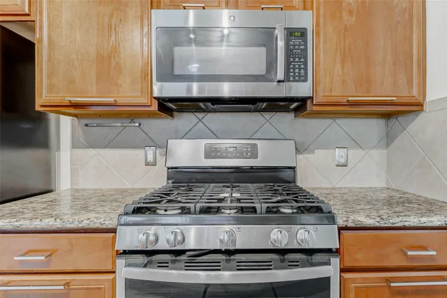 a stove top oven sitting inside of a kitchen