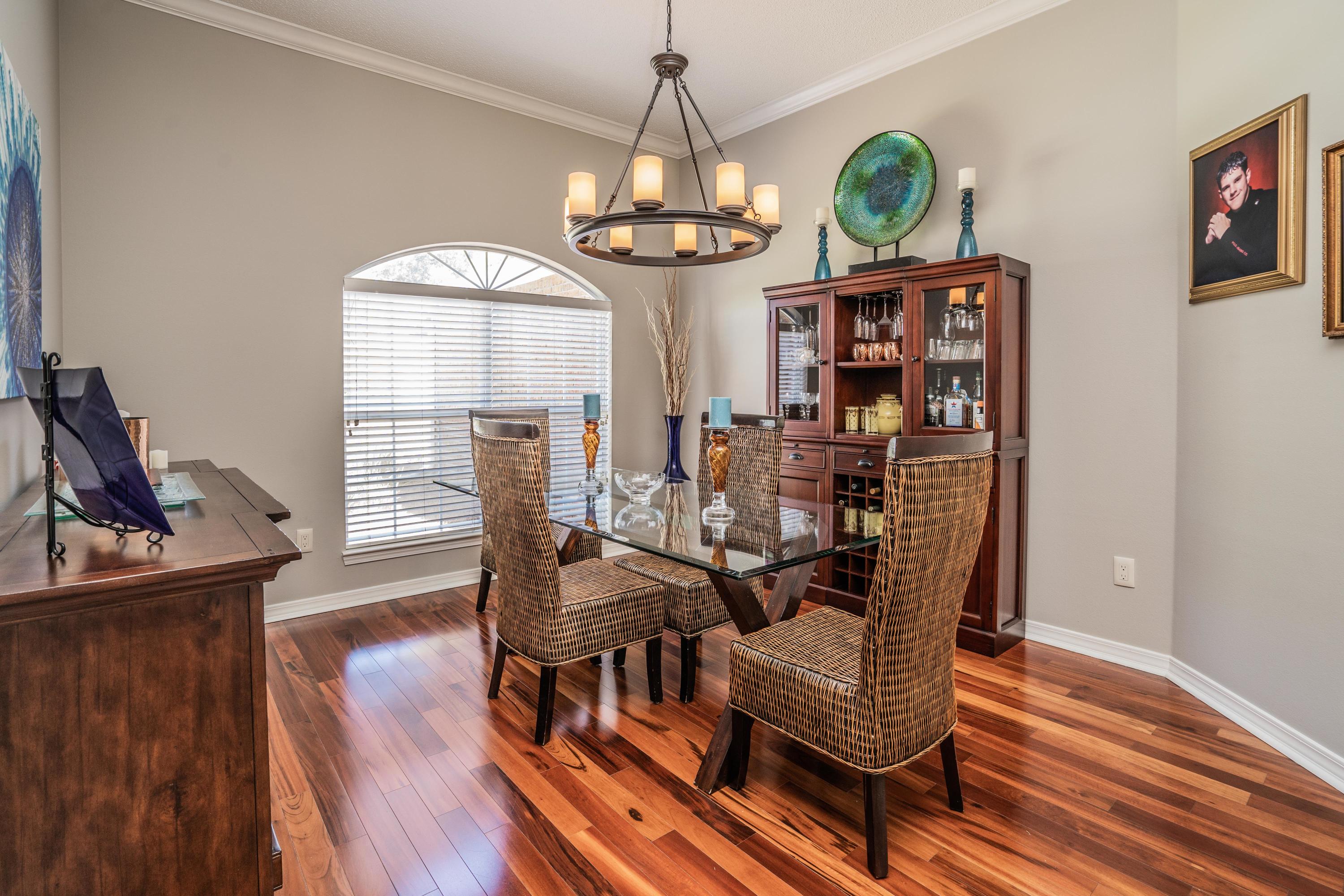 4258 Shadow Lane Niceville, FL 32578 - Photo 13 of 36 a view of a dining room with furniture wooden floor and chandelier