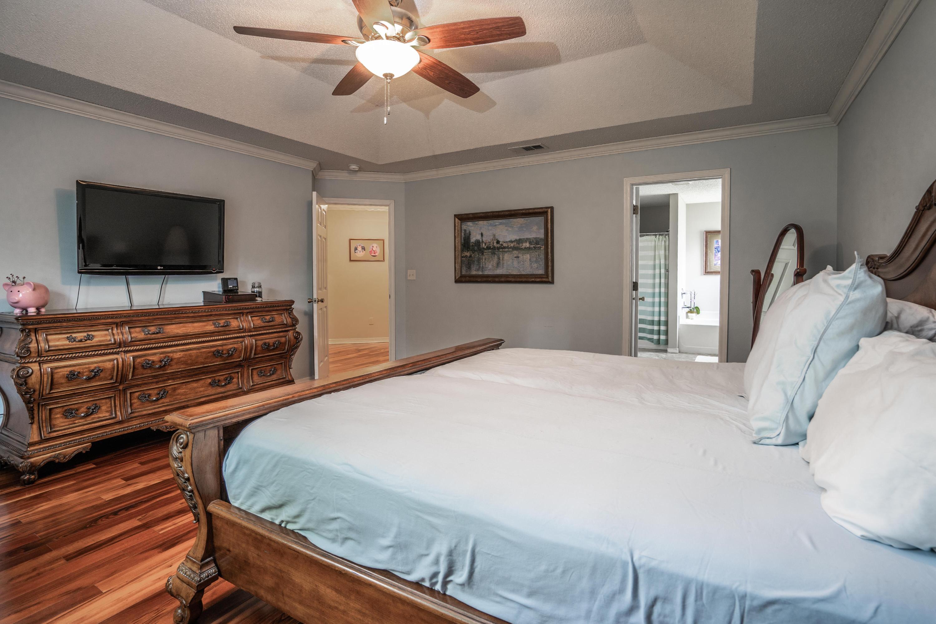 4258 Shadow Lane Niceville, FL 32578 - Photo 16 of 36 a bedroom with a bed and a flat screen tv