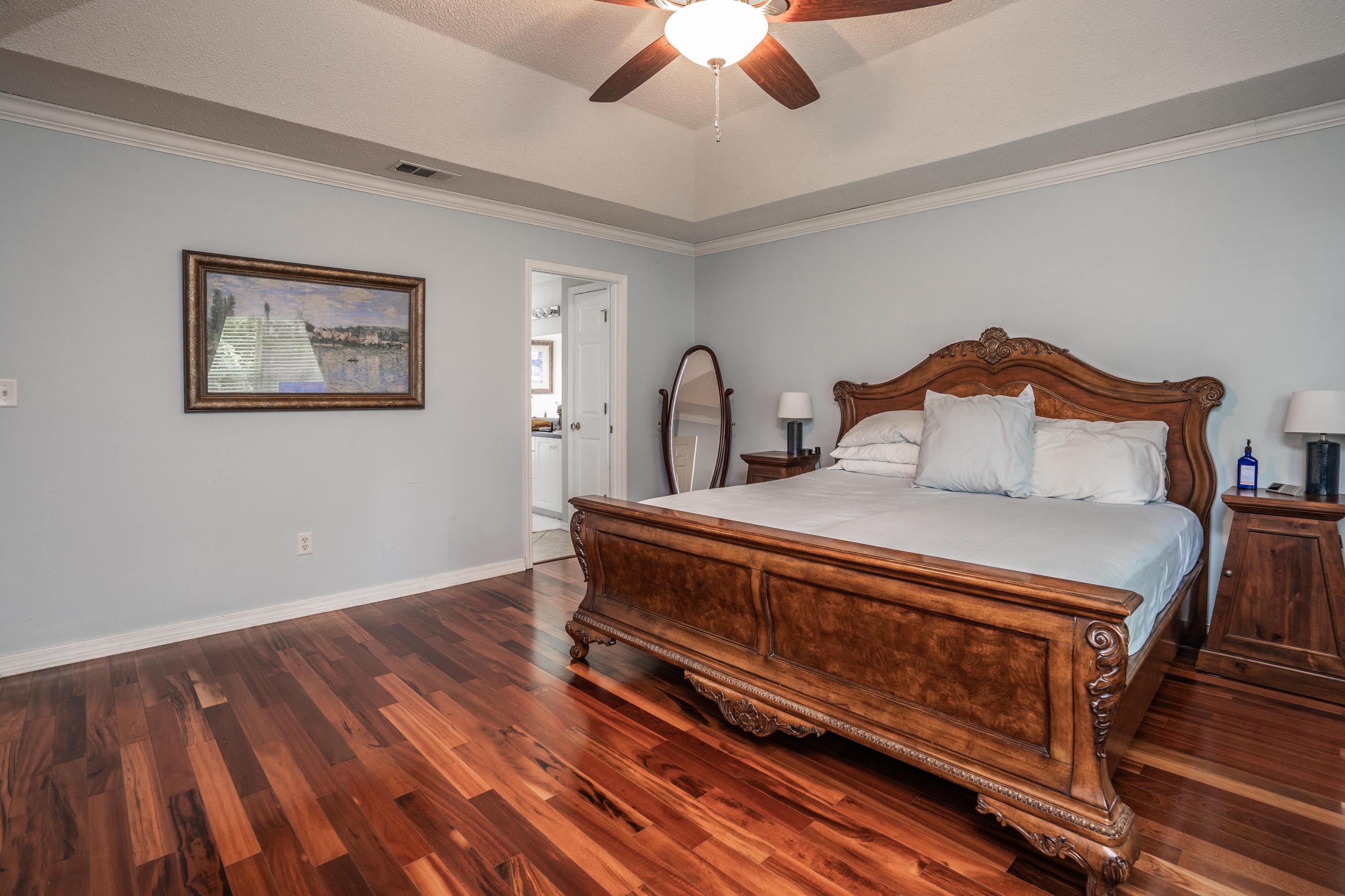 4258 Shadow Lane Niceville, FL 32578 - Photo 17 of 36 a bedroom with a bed and a chandelier