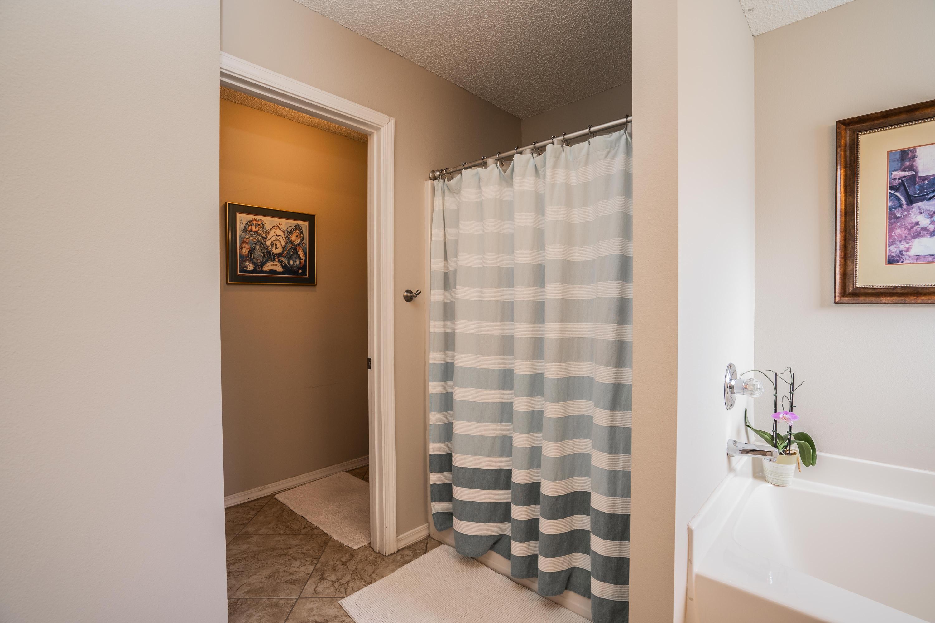 4258 Shadow Lane Niceville, FL 32578 - Photo 19 of 36 a bathroom with a bathtub and shower