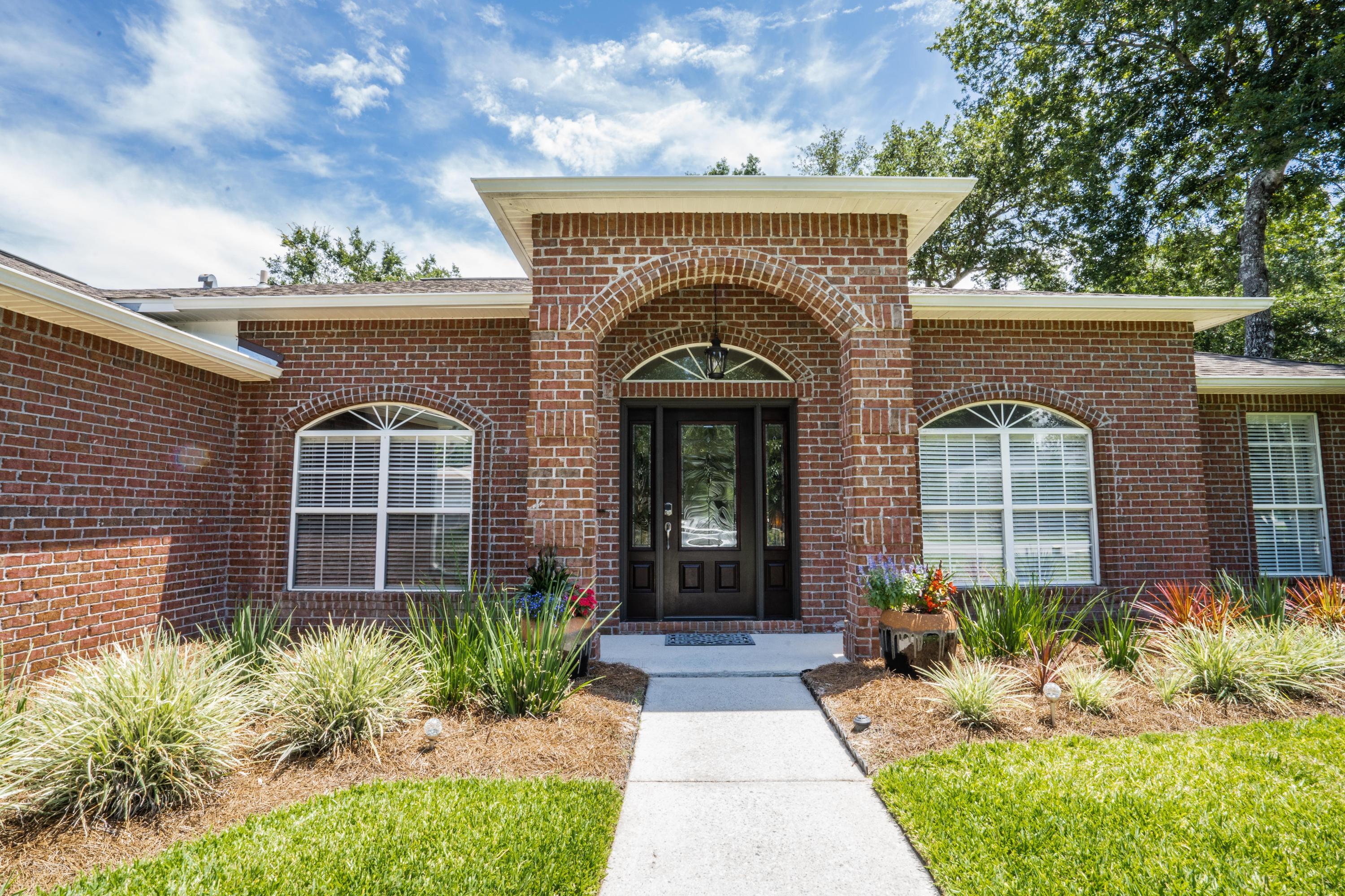 4258 Shadow Lane Niceville, FL 32578 - Photo 2 of 36 a front view of a house with a garden