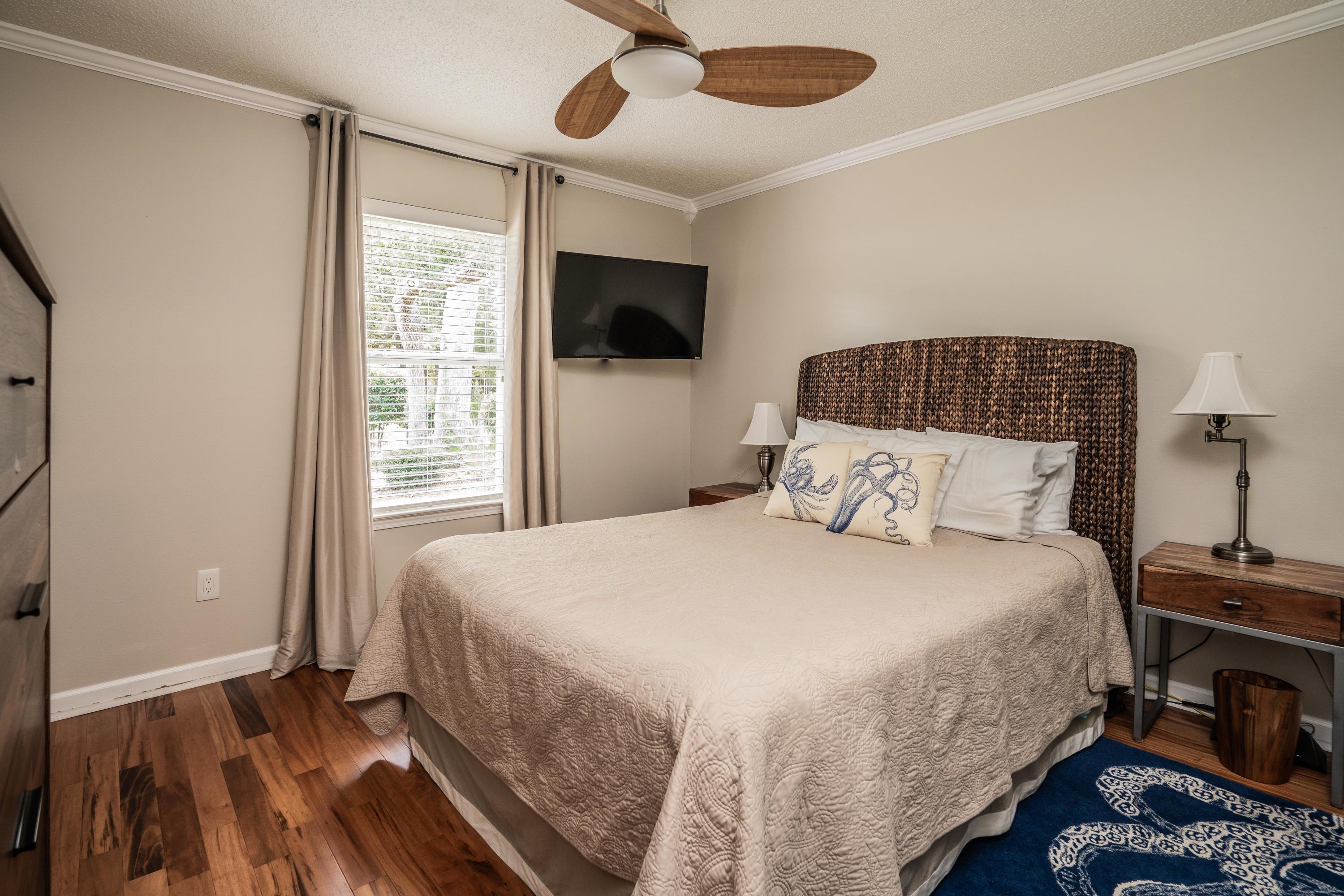 4258 Shadow Lane Niceville, FL 32578 - Photo 22 of 36 a bedroom with a bed and a flat tv screen