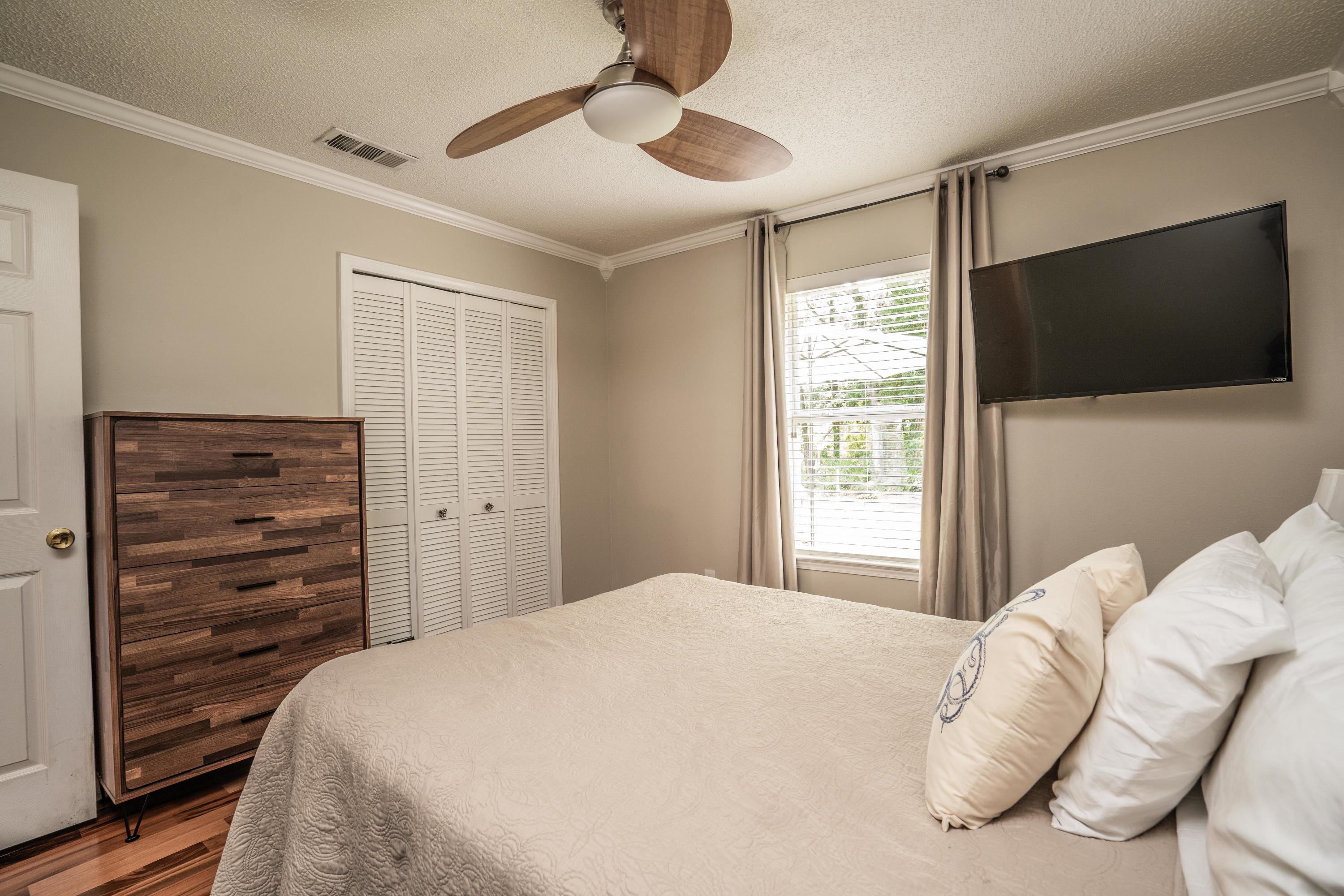4258 Shadow Lane Niceville, FL 32578 - Photo 24 of 36 a bedroom with a bed and a flat screen tv