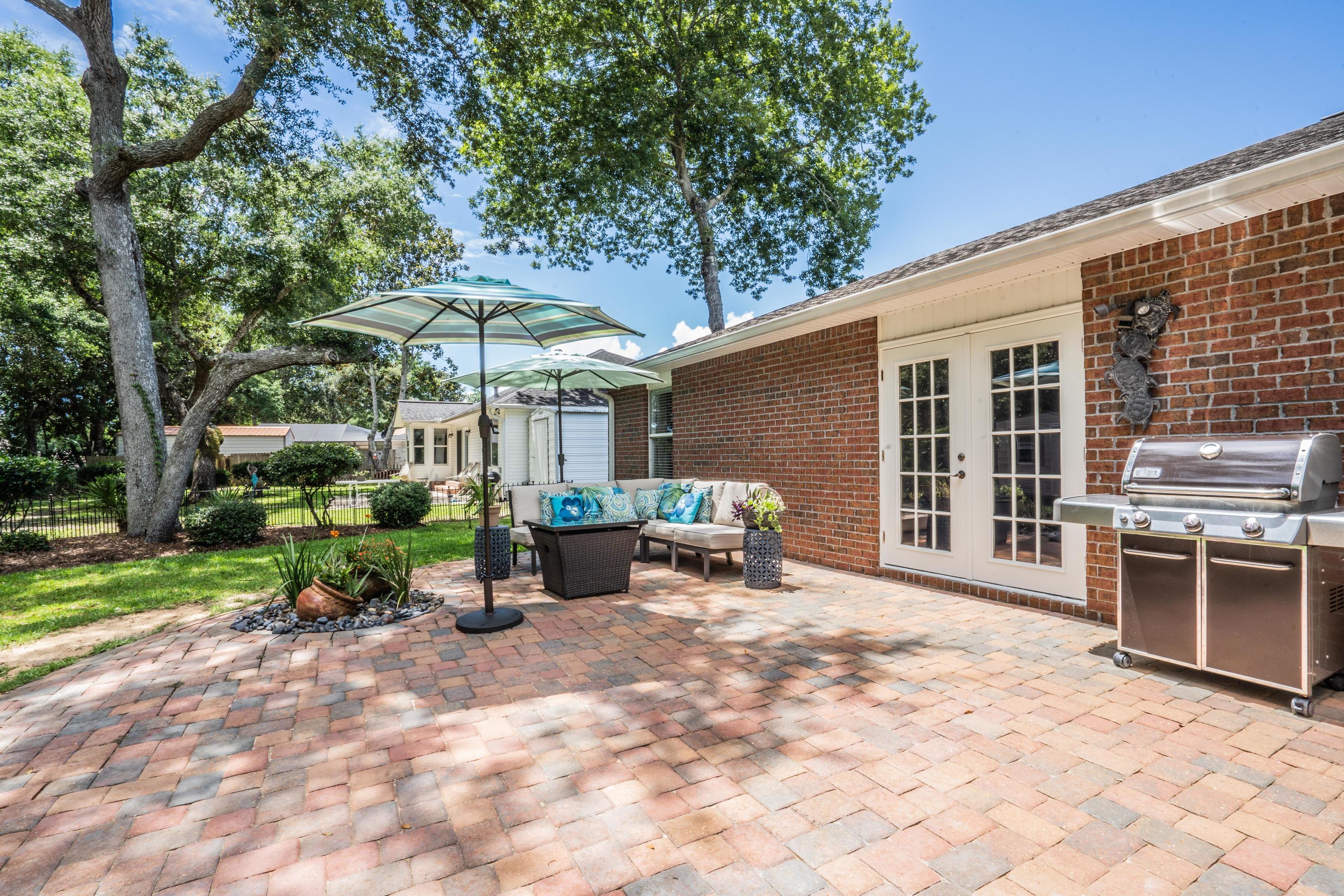 4258 Shadow Lane Niceville, FL 32578 - Photo 30 of 36 a view of a house with backyard sitting area and garden