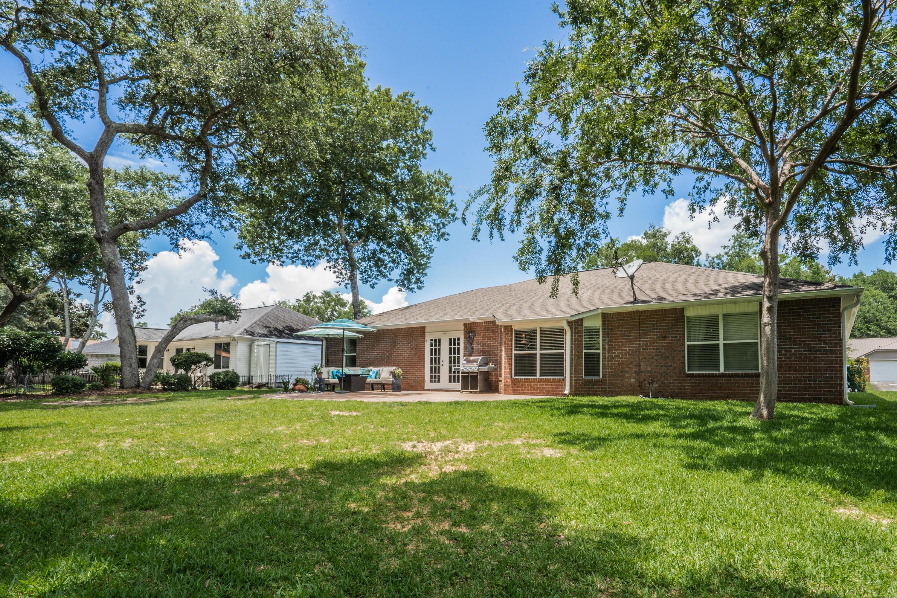 4258 Shadow Lane Niceville, FL 32578 - Photo 31 of 36 a view of a house with a yard deck and sitting area