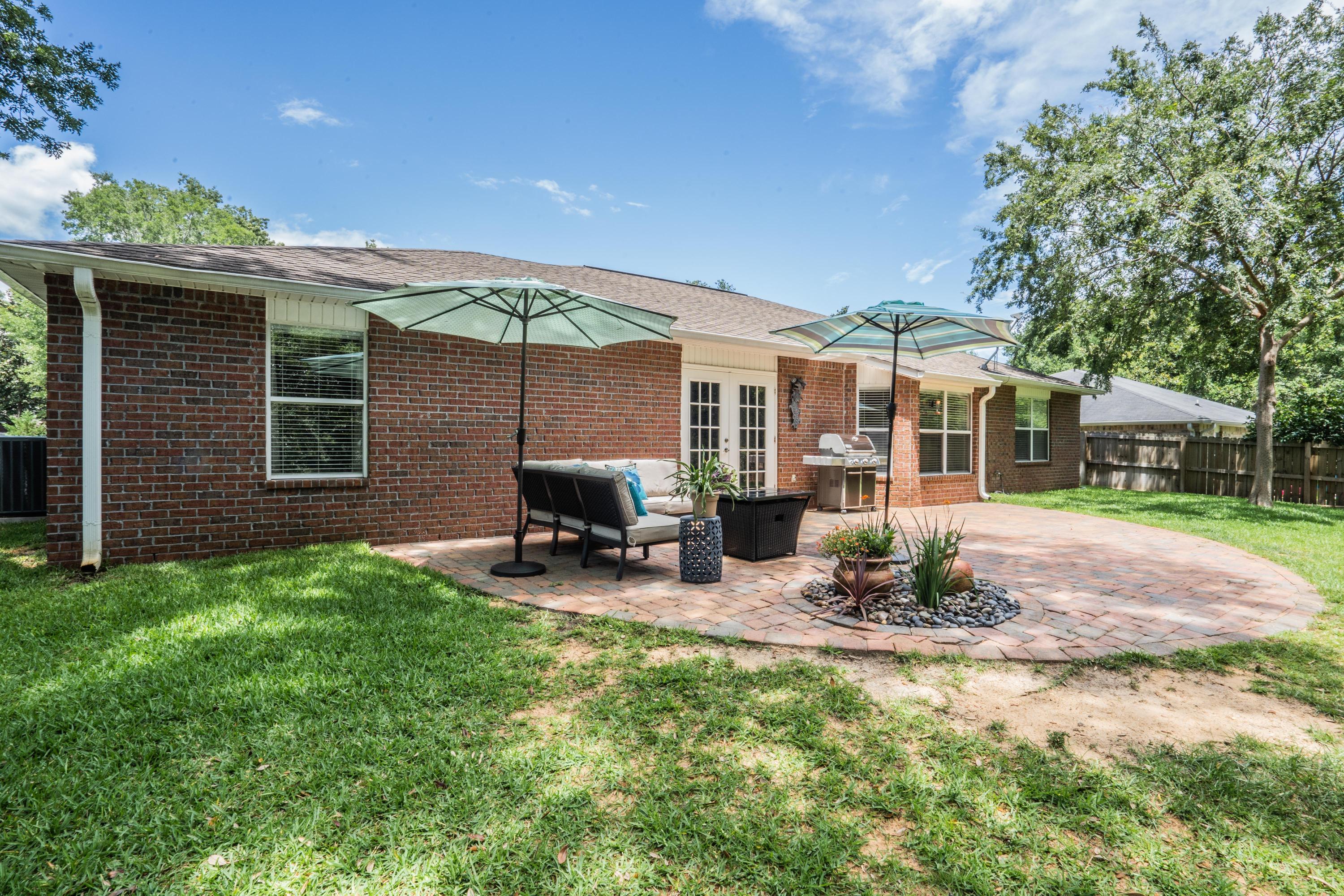 4258 Shadow Lane Niceville, FL 32578 - Photo 32 of 36 a view of a house with backyard porch and sitting area