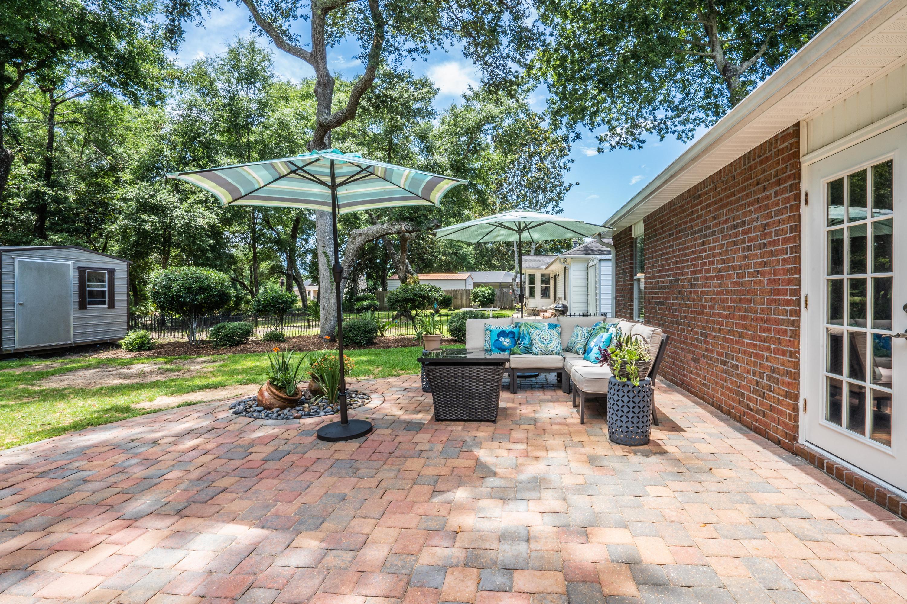 4258 Shadow Lane Niceville, FL 32578 - Photo 33 of 36 a view of a patio with table and chairs potted plants with wooden fence