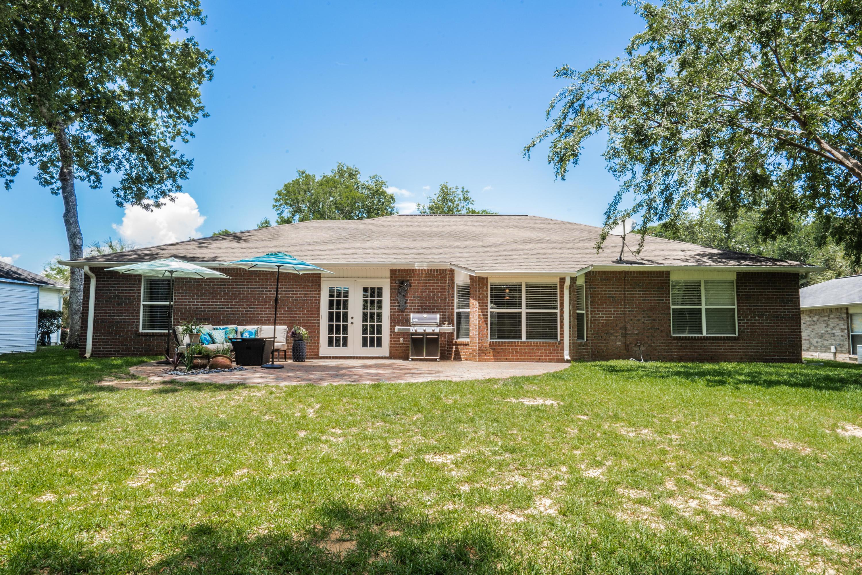 4258 Shadow Lane Niceville, FL 32578 - Photo 34 of 36 a view of a house with a yard and sitting area