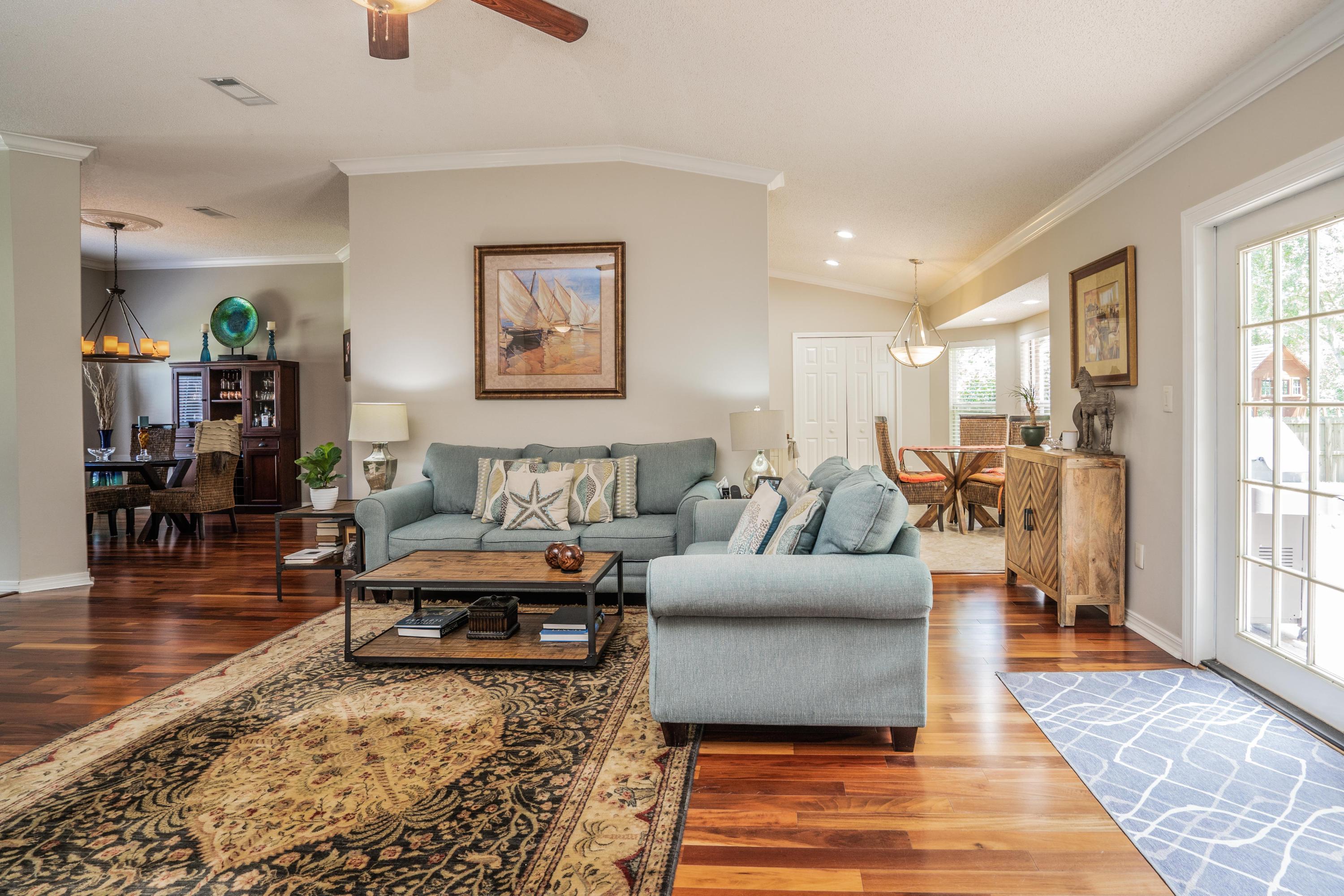 4258 Shadow Lane Niceville, FL 32578 - Photo 9 of 36 a living room with furniture and wooden floor