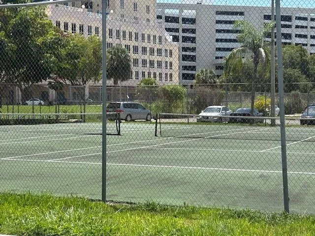 a view of a city with tall buildings and a big yard