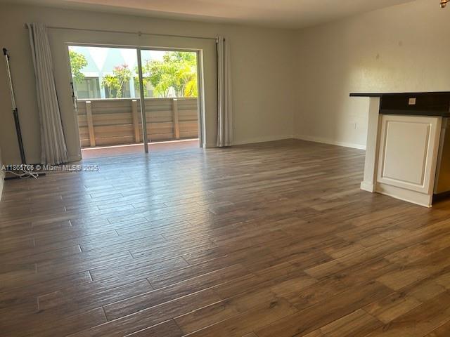 8325 Southwest 72nd Avenue, Unit 205C Miami, FL 33143 - Photo 2 of 14 wooden floor in an empty room with a window