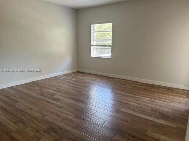8325 Southwest 72nd Avenue, Unit 205C Miami, FL 33143 - Photo 5 of 14 an empty room with wooden floor and windows