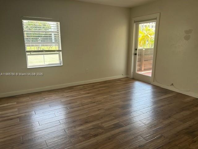 8325 Southwest 72nd Avenue, Unit 205C Miami, FL 33143 - Photo 6 of 14 a view of an empty room with wooden floor and a window