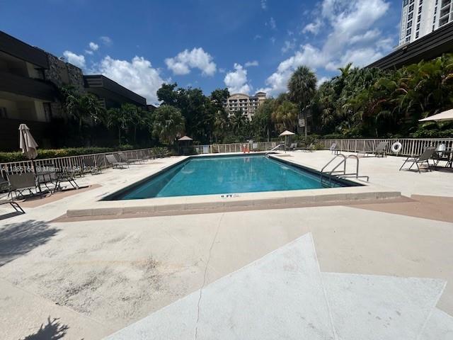 8325 Southwest 72nd Avenue, Unit 205C Miami, FL 33143 - Photo 9 of 14 a view of a swimming pool with a patio