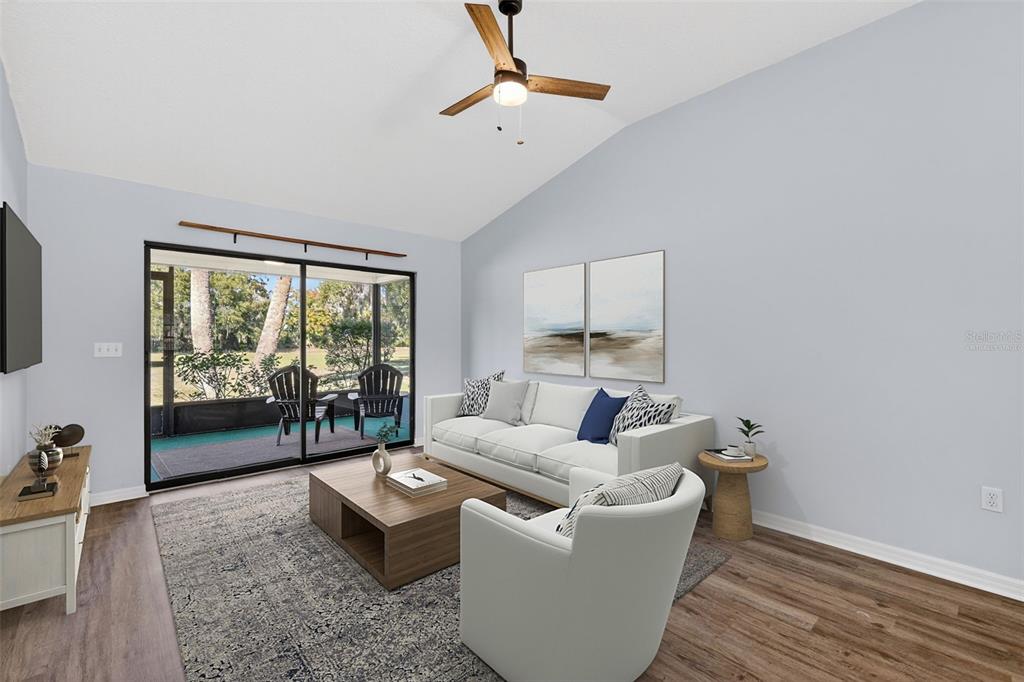 579 Juniper Way Tavares, FL 32778 - Photo 13 of 46 a living room with furniture and a large window