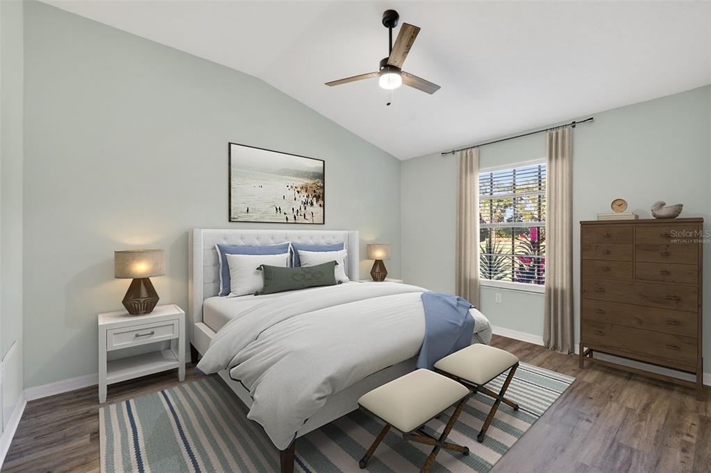 579 Juniper Way Tavares, FL 32778 - Photo 17 of 46 a bedroom with a bed and wooden floor