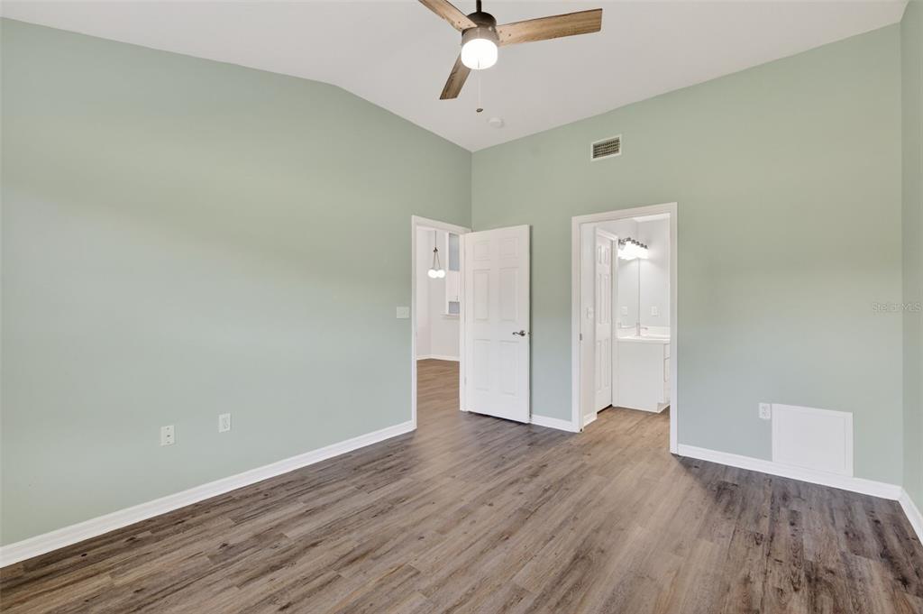 579 Juniper Way Tavares, FL 32778 - Photo 19 of 46 wooden floor in an empty room with a window