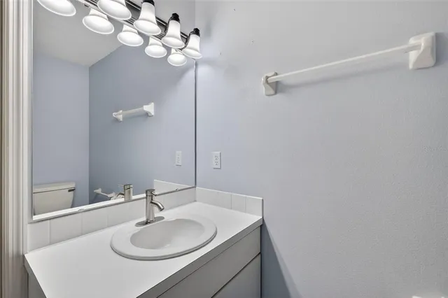 a bathroom with a sink vanity and a mirror
