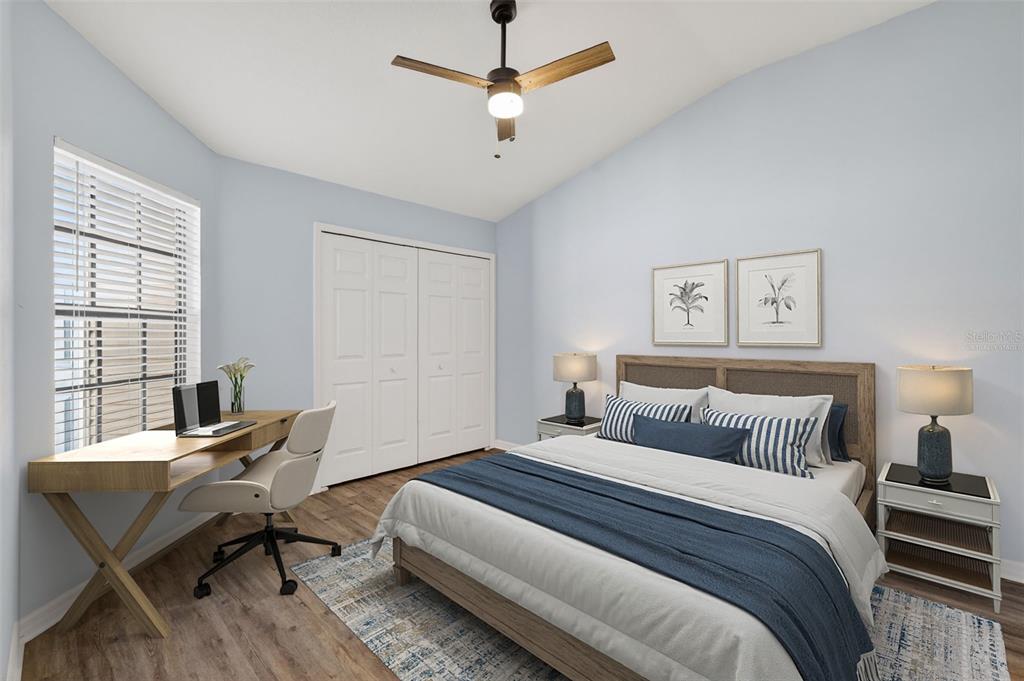 579 Juniper Way Tavares, FL 32778 - Photo 23 of 46 a bedroom with a bed and a desk