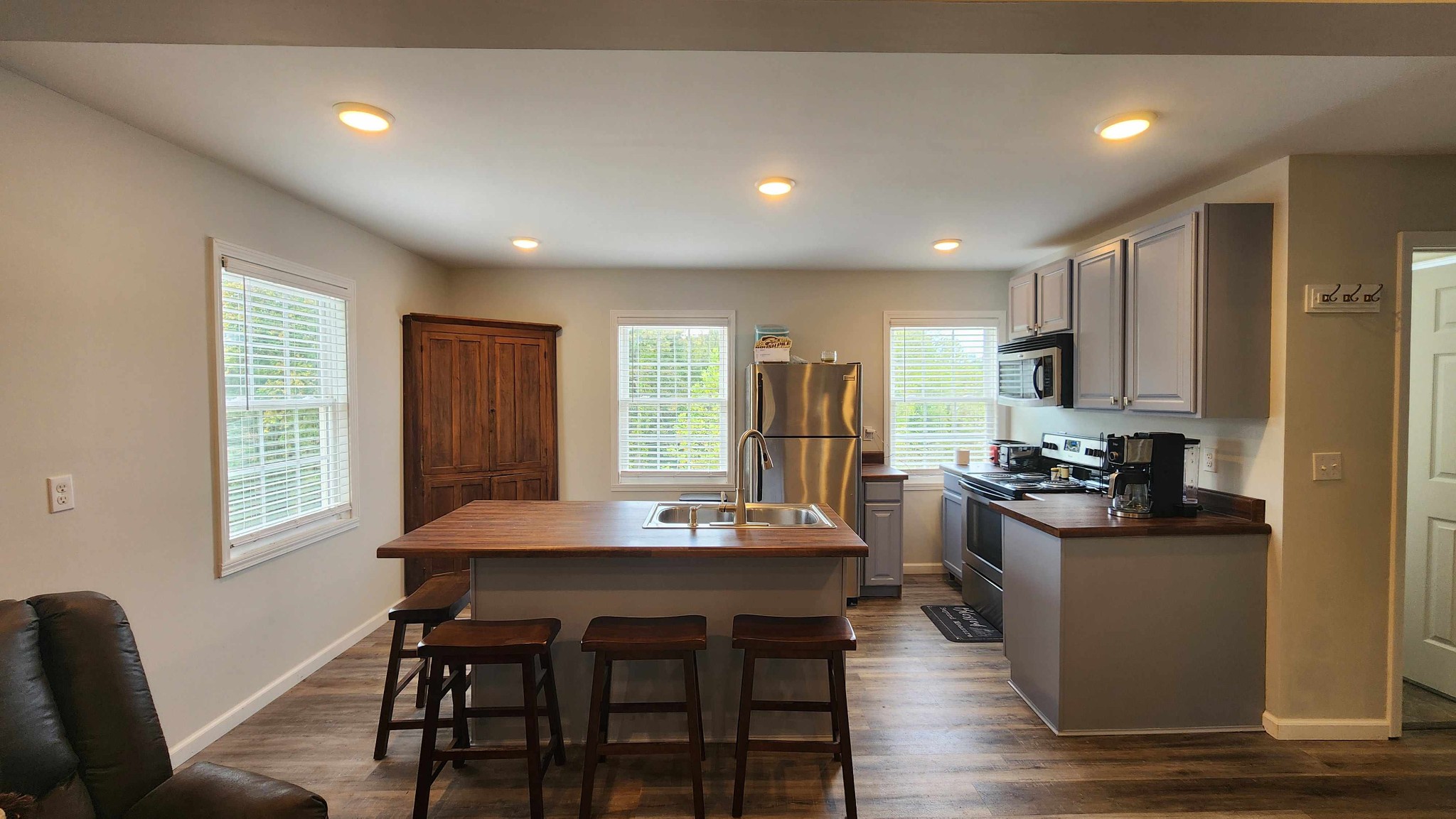 281 Bill Hunter Road Celina, TN 38551 - Photo 13 of 55 a kitchen with stainless steel appliances granite countertop a stove a refrigerator a kitchen island and chairs in it
