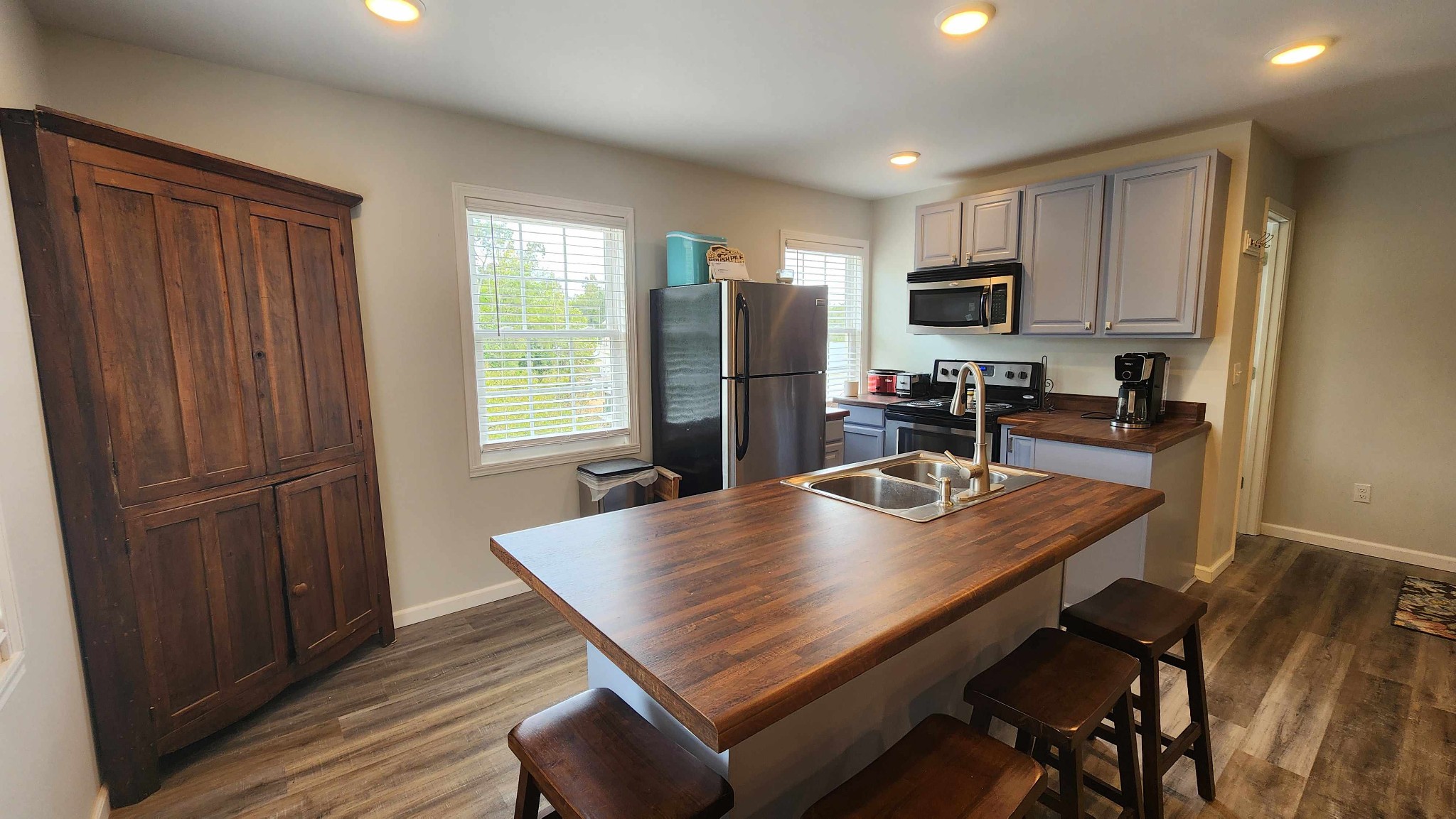 281 Bill Hunter Road Celina, TN 38551 - Photo 15 of 55 a kitchen with a table chairs refrigerator and cabinets