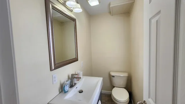 a white toilet sitting next to a bathroom sink