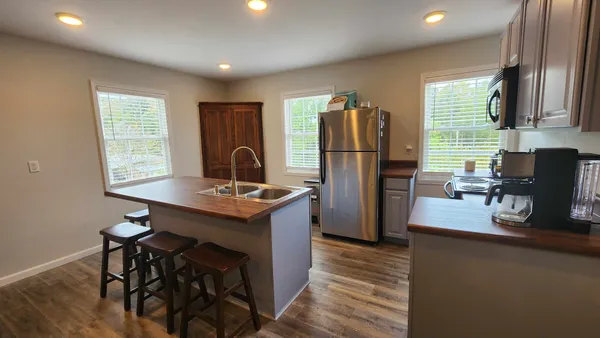 a kitchen with refrigerator and window