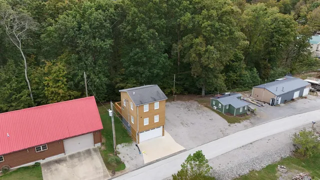 an aerial view of a house with a yard