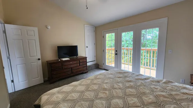 a bedroom with a bed and a television