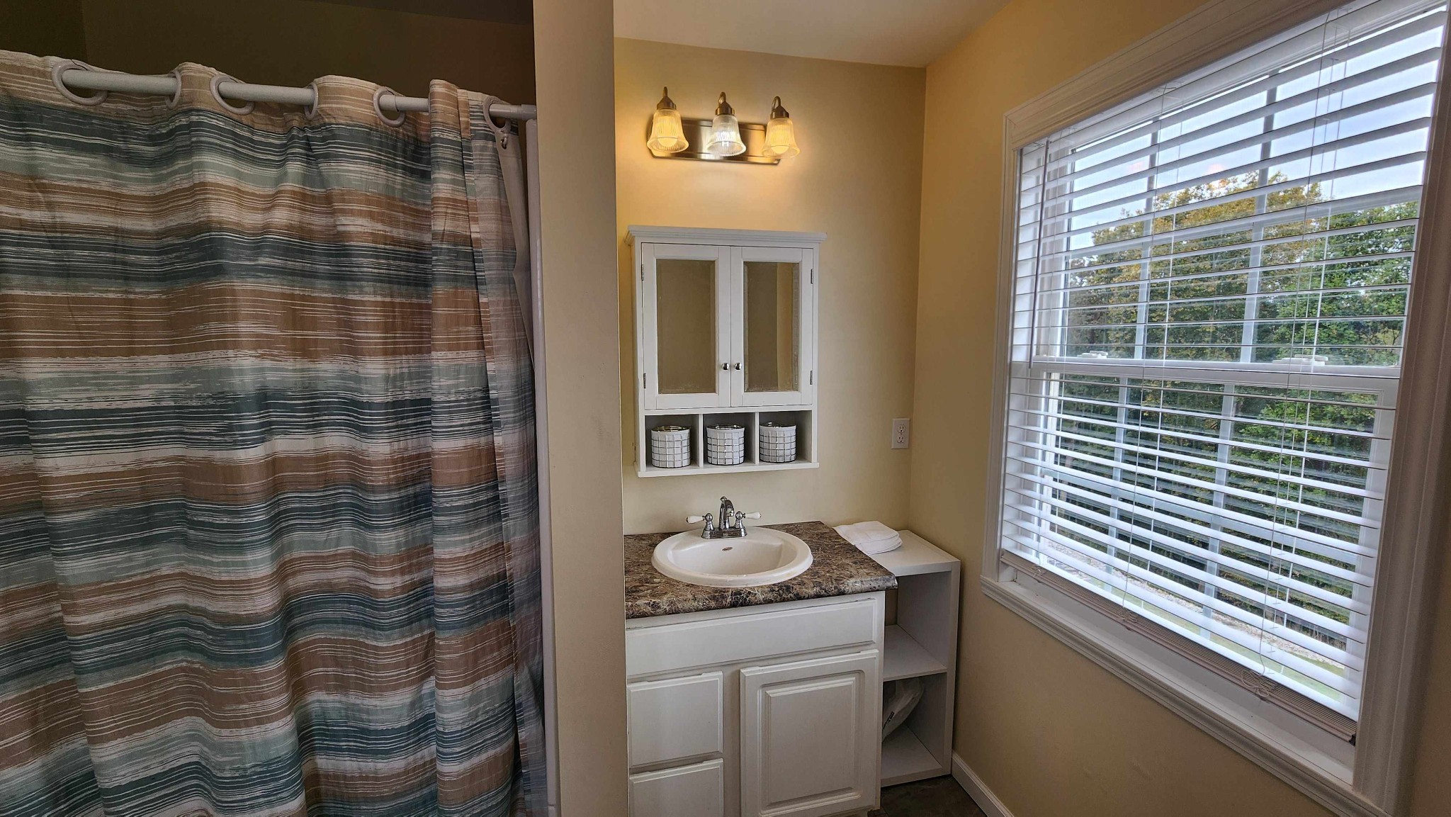 281 Bill Hunter Road Celina, TN 38551 - Photo 10 of 55 a bathroom with a sink a mirror and a shower