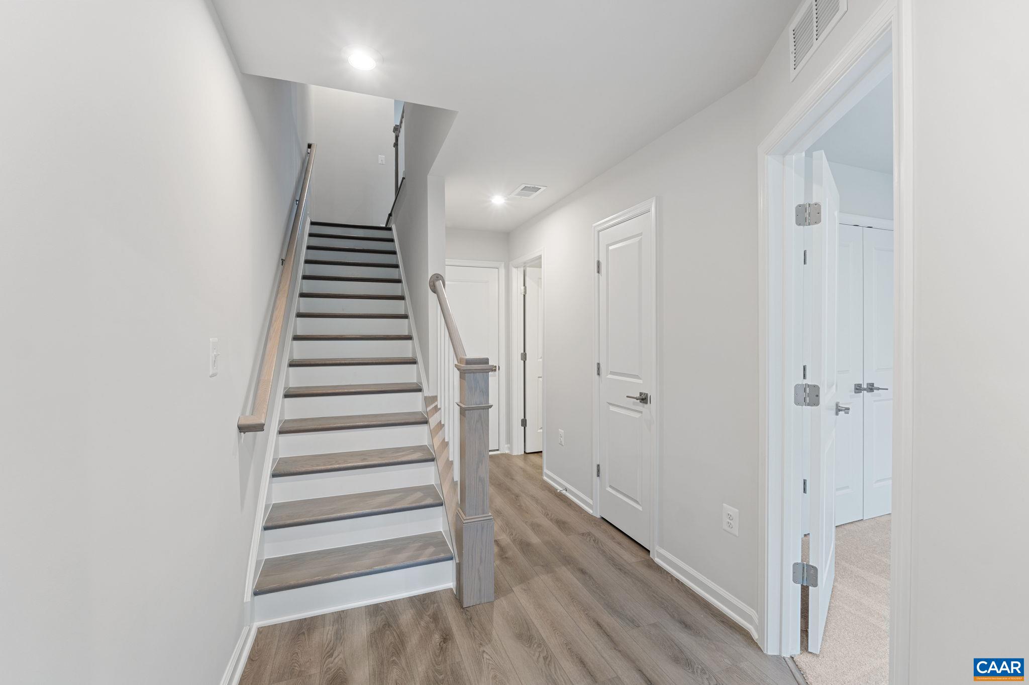 2249 Woodburn Road Charlottesville, VA 22901 - Photo 2 of 34 a view of hallway with stairs and wooden floor