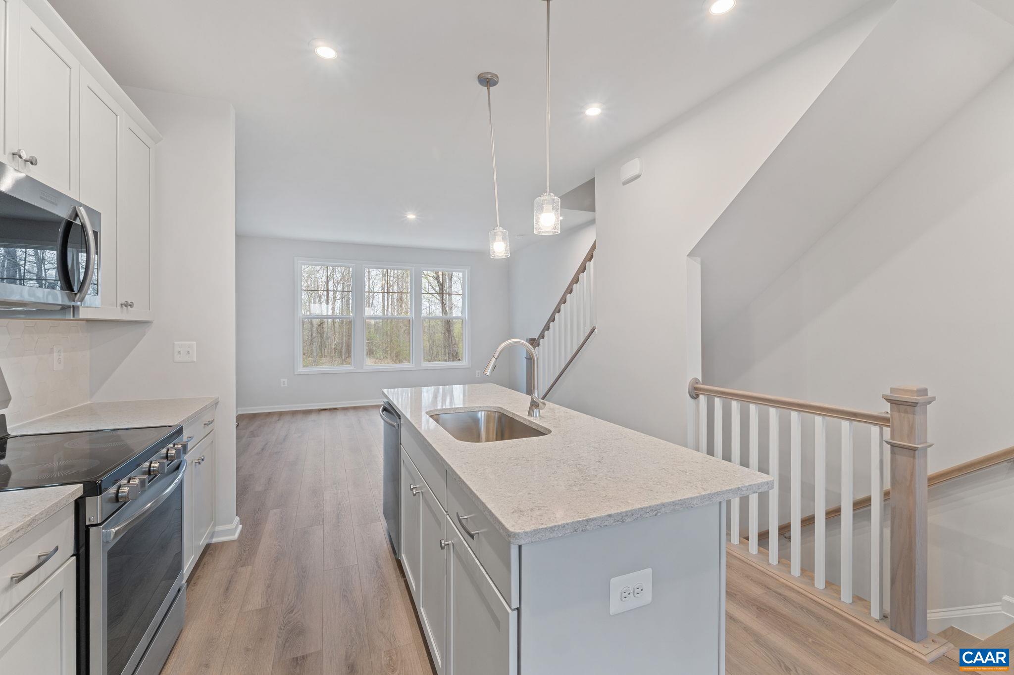 2249 Woodburn Road Charlottesville, VA 22901 - Photo 3 of 34 a kitchen with a stove a sink and a refrigerator