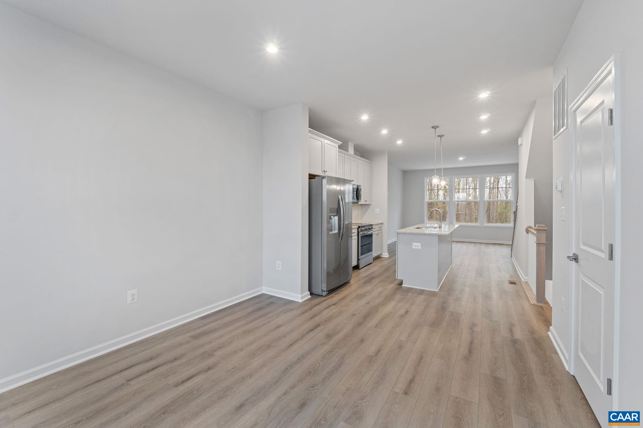 2249 Woodburn Road Charlottesville, VA 22901 - Photo 5 of 34 a view of a kitchen with refrigerator and wooden floor