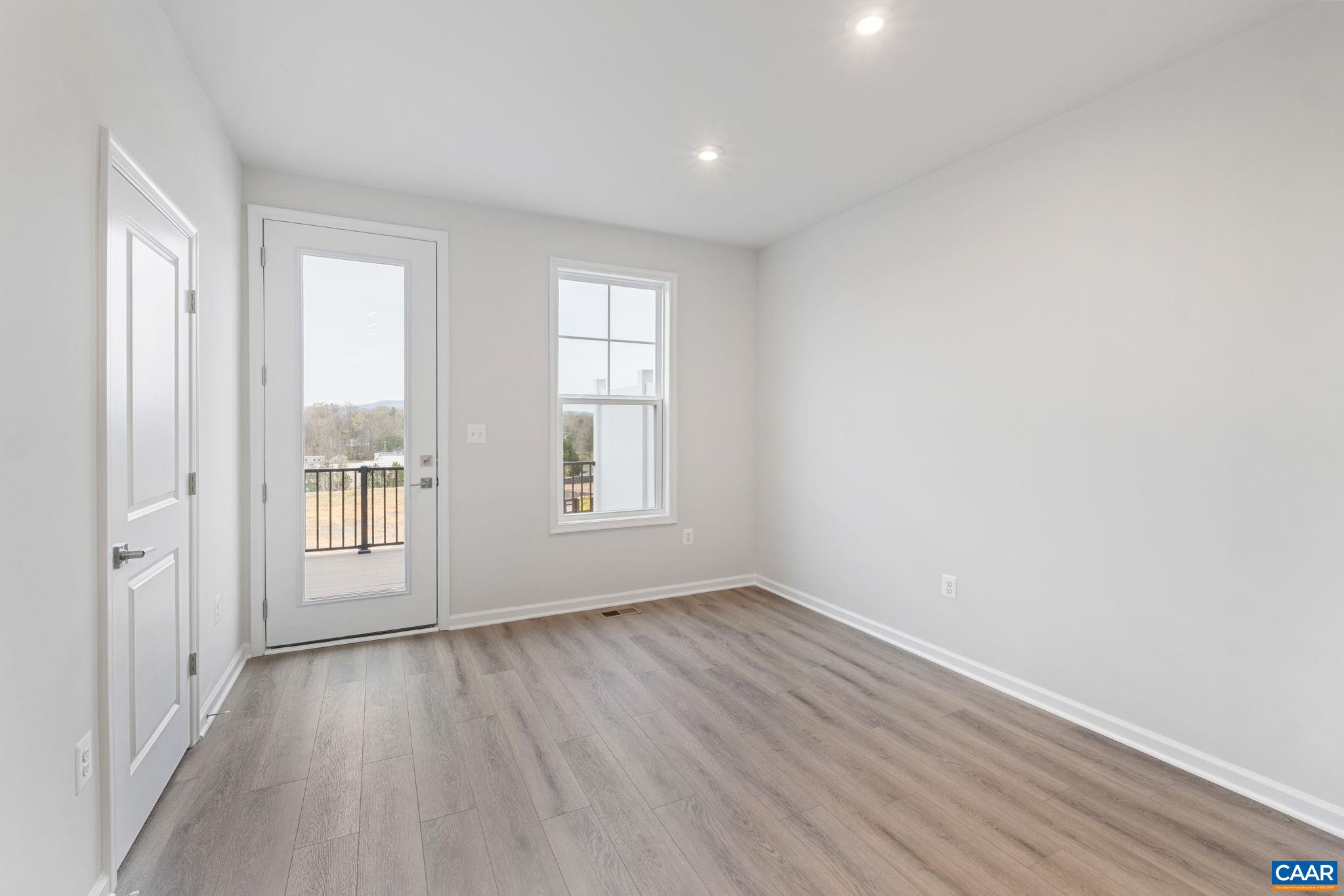 2249 Woodburn Road Charlottesville, VA 22901 - Photo 6 of 34 wooden floor in an empty room with a window