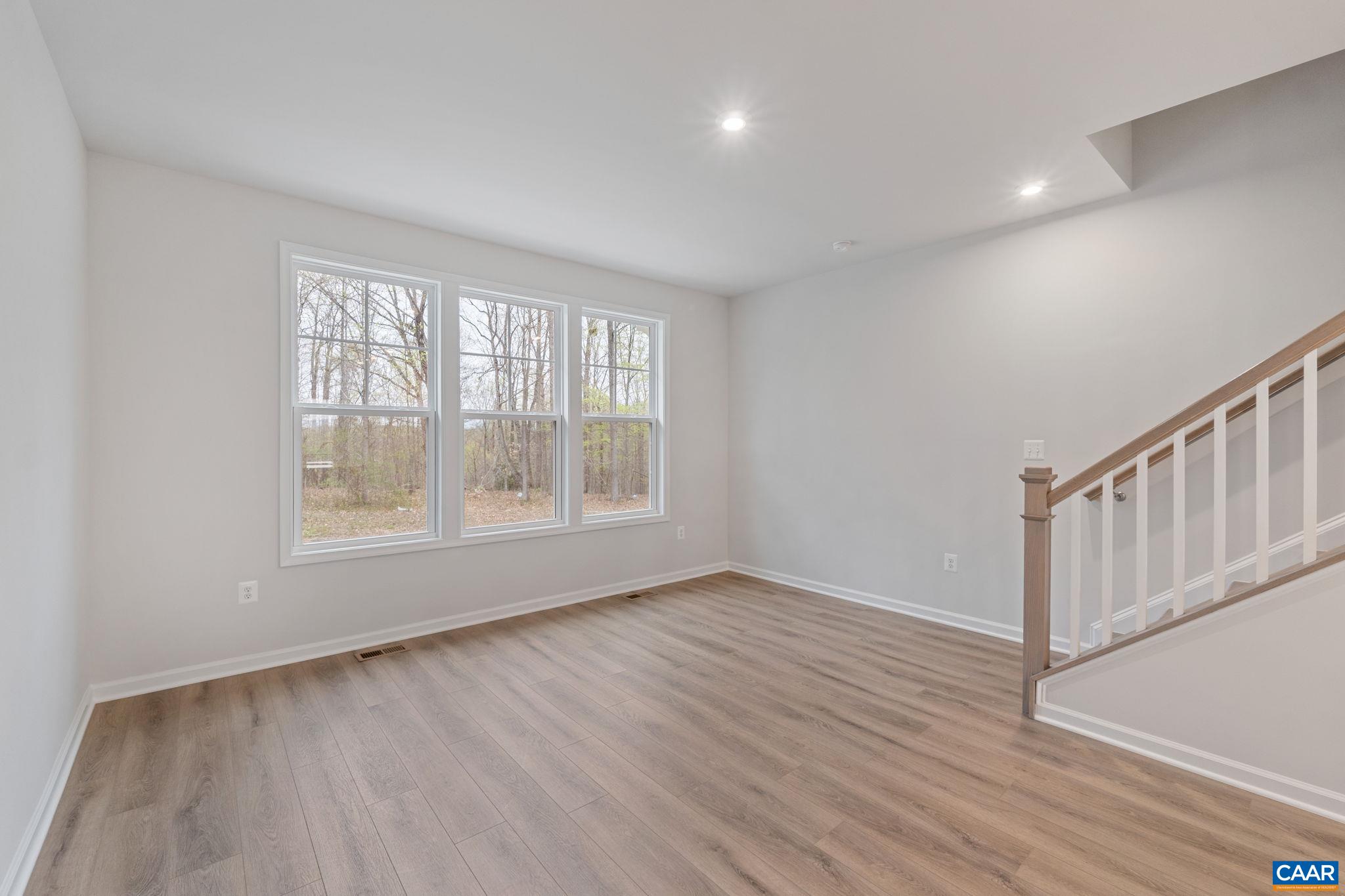 2249 Woodburn Road Charlottesville, VA 22901 - Photo 9 of 34 a view of an empty room with wooden floor and a window