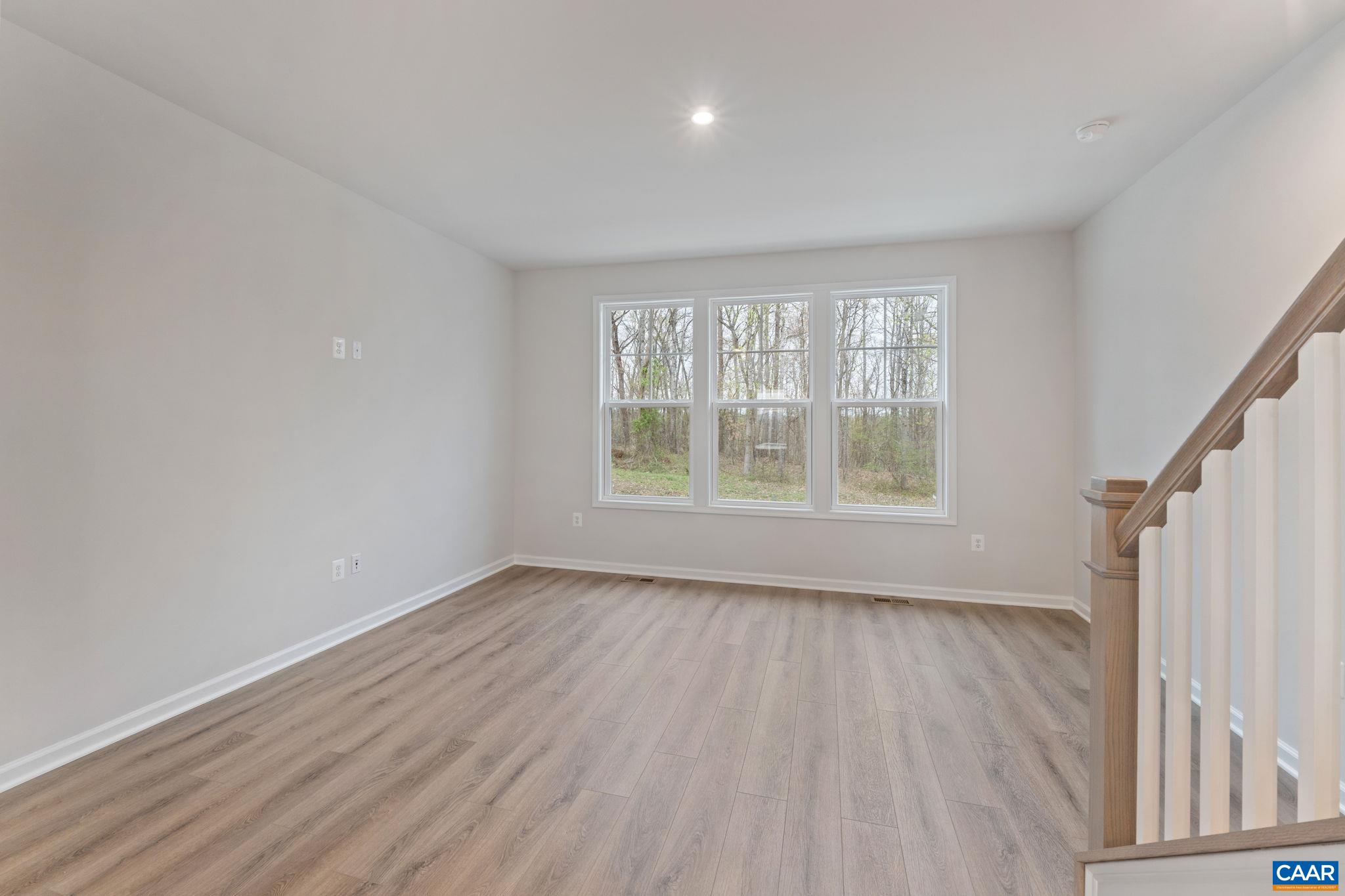 2249 Woodburn Road Charlottesville, VA 22901 - Photo 10 of 34 a view of an empty room with wooden floor and a window