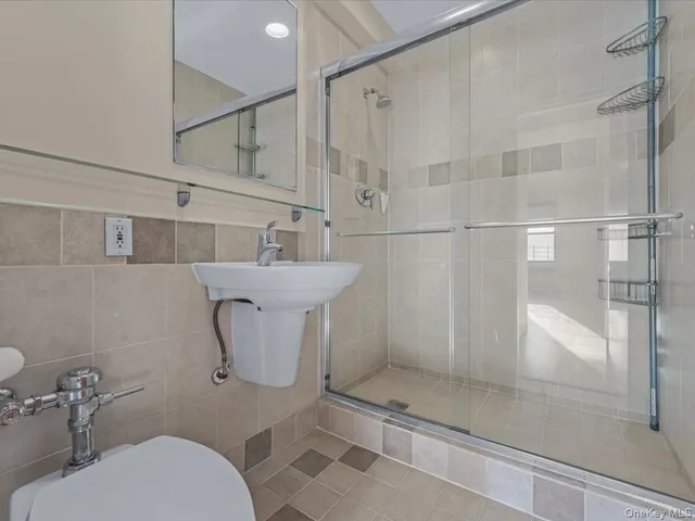 a bathroom with a toilet sink and shower