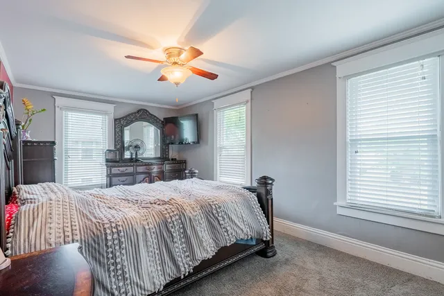 a bedroom with a large bed and a window